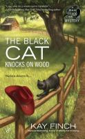 The_black_cat_knocks_on_wood